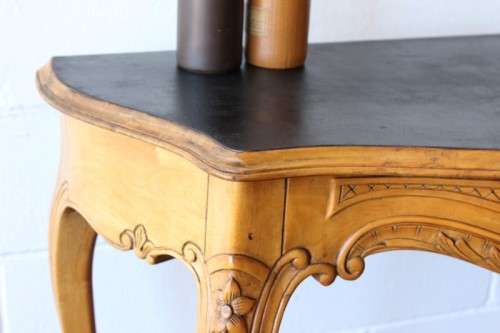 A beautiful ornately carved Yew wood console/ hall table with an ebony stained top on cabriole legs