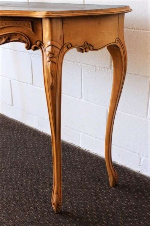 A beautiful ornately carved Yew wood console/ hall table with an ebony stained top on cabriole legs