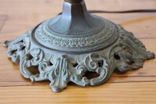 A stunning vintage milk-glass table lamp with floral transfer work on a brass tone metal base