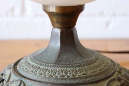 A stunning vintage milk-glass table lamp with floral transfer work on a brass tone metal base