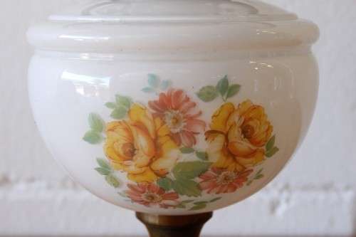 A stunning vintage milk-glass table lamp with floral transfer work on a brass tone metal base