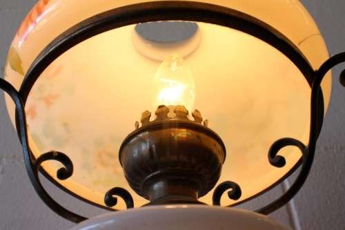 A stunning vintage milk-glass table lamp with floral transfer work on a brass tone metal base