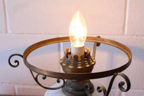 A stunning vintage milk-glass table lamp with floral transfer work on a brass tone metal base