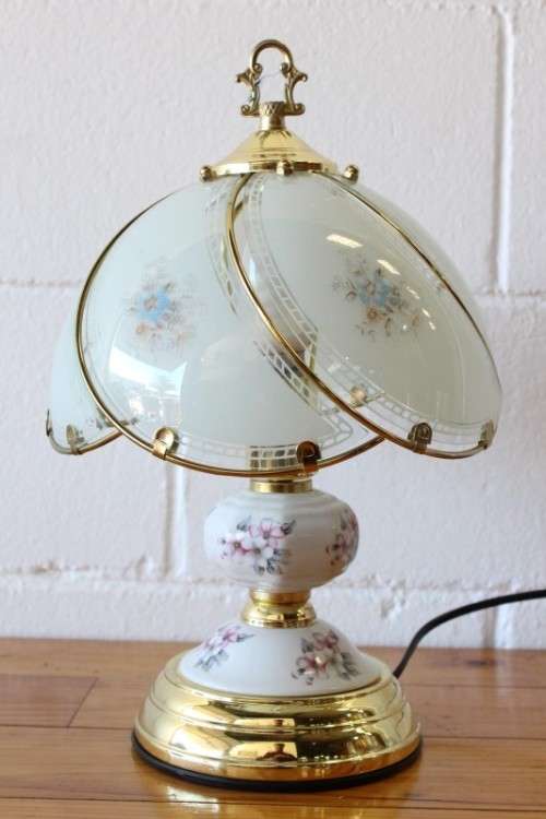 A lovely parlour table lamp with a glass panelled shade and brass-finished base - stunning on a desk