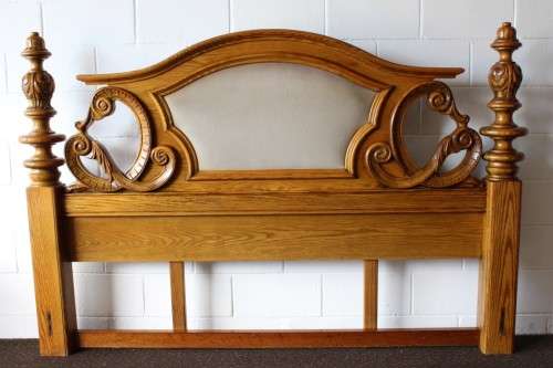 A stunning ornately carved solid Oak headboard and footboard set with upholstered centre panels!