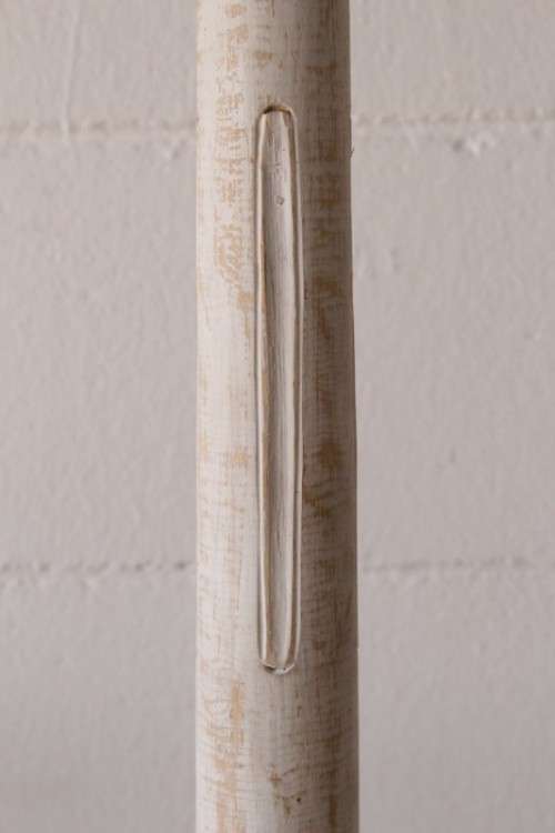 A pair of tall white chalk-painted carved wooden candle stands - perfect ambience lighting
