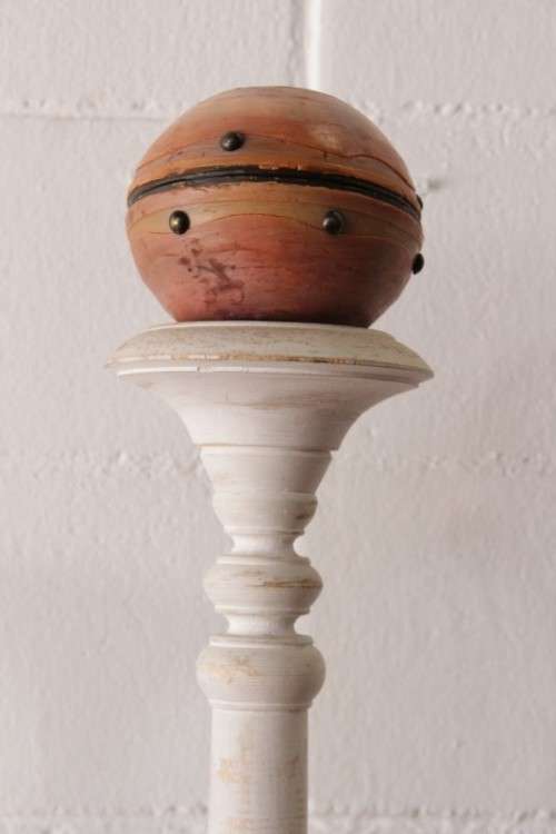 A pair of tall white chalk-painted carved wooden candle stands - perfect ambience lighting