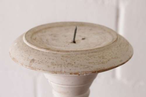 A pair of tall white chalk-painted carved wooden candle stands - perfect ambience lighting