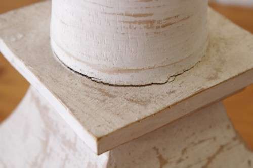 A pair of tall white chalk-painted carved wooden candle stands - perfect ambience lighting