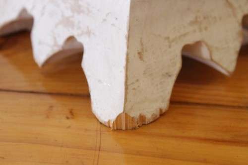 A pair of tall white chalk-painted carved wooden candle stands - perfect ambience lighting