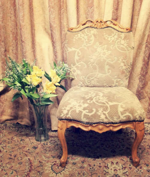 **RS17** A gorgeous Victorian "parlour chair" with carved detailing and floral upholstery.