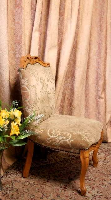 **RS17** A gorgeous Victorian "parlour chair" with carved detailing and floral upholstery.