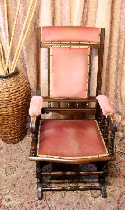 A lovely vintage Imbuia Victorian styled platform rocking chair with dusty pink upholstery.
