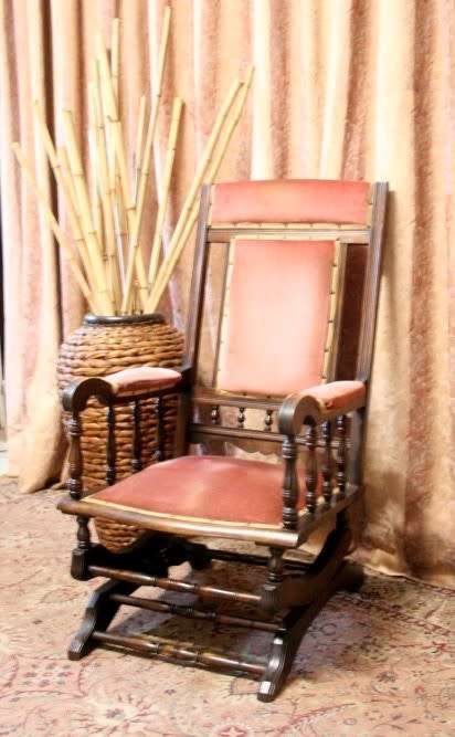 A lovely vintage Imbuia Victorian styled platform rocking chair with dusty pink upholstery.