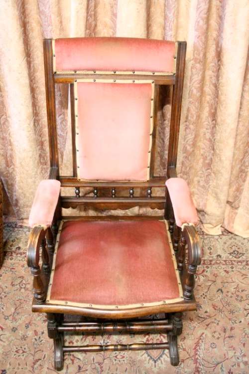 A lovely vintage Imbuia Victorian styled platform rocking chair with dusty pink upholstery.