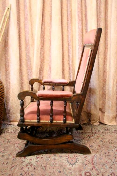 A lovely vintage Imbuia Victorian styled platform rocking chair with dusty pink upholstery.