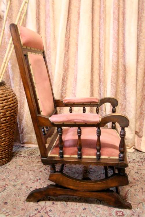A lovely vintage Imbuia Victorian styled platform rocking chair with dusty pink upholstery.