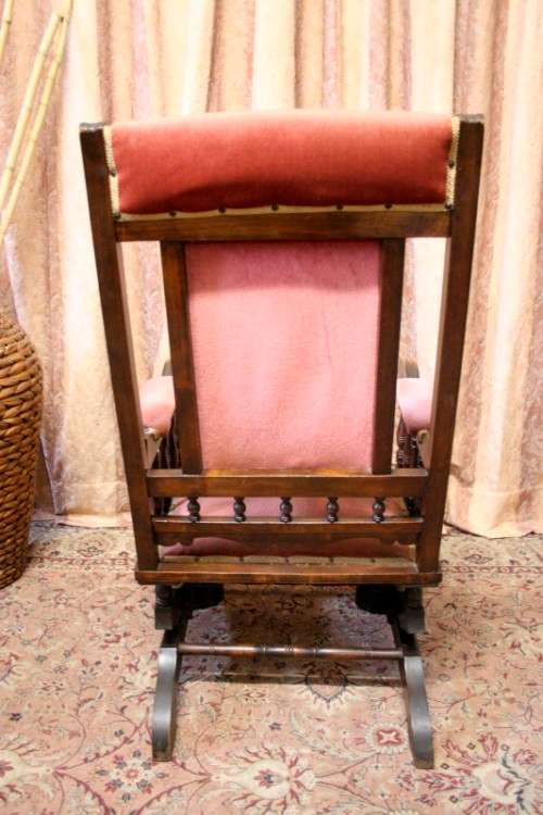 A lovely vintage Imbuia Victorian styled platform rocking chair with dusty pink upholstery.