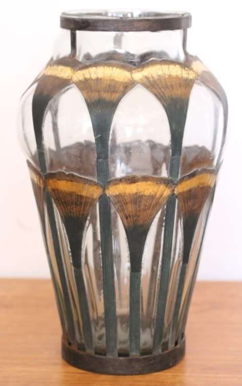 An extremely rare hand blown "caged" glass vase with a handmade & painted metal papyrus cage