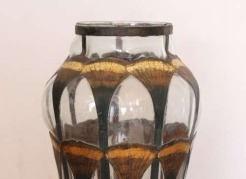 An extremely rare hand blown "caged" glass vase with a handmade & painted metal papyrus cage