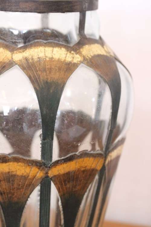 An extremely rare hand blown "caged" glass vase with a handmade & painted metal papyrus cage