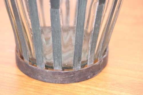 An extremely rare hand blown "caged" glass vase with a handmade & painted metal papyrus cage
