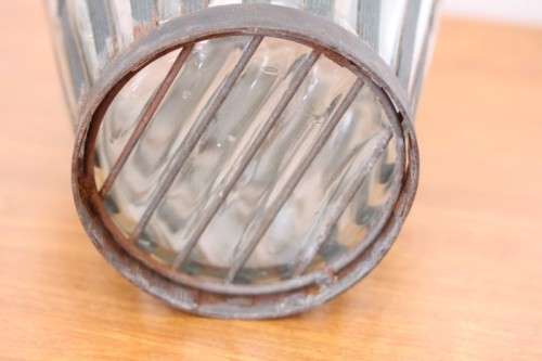 An extremely rare hand blown "caged" glass vase with a handmade & painted metal papyrus cage