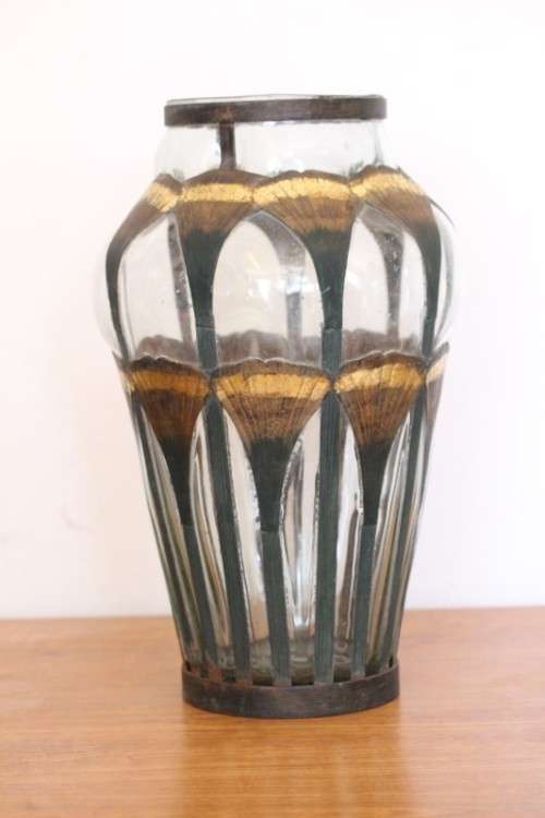 An extremely rare hand blown "caged" glass vase with a handmade & painted metal papyrus cage