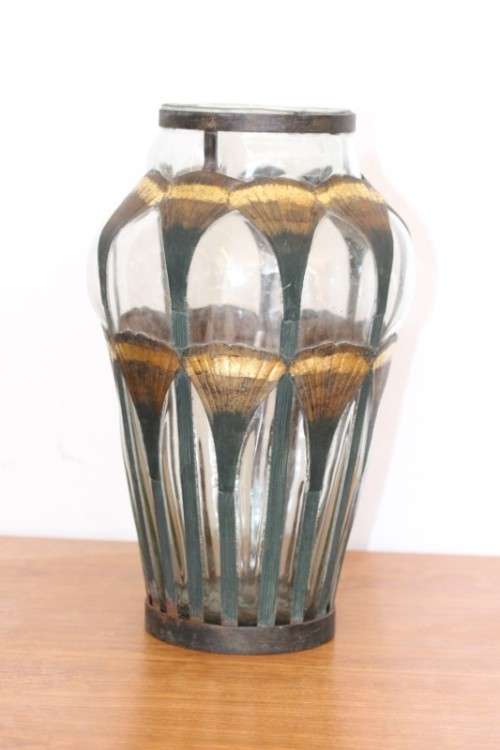 An extremely rare hand blown "caged" glass vase with a handmade & painted metal papyrus cage