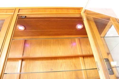 **RS17** A tall 3-door oak display cabinet with lighting, four drawers and two storage cupboards