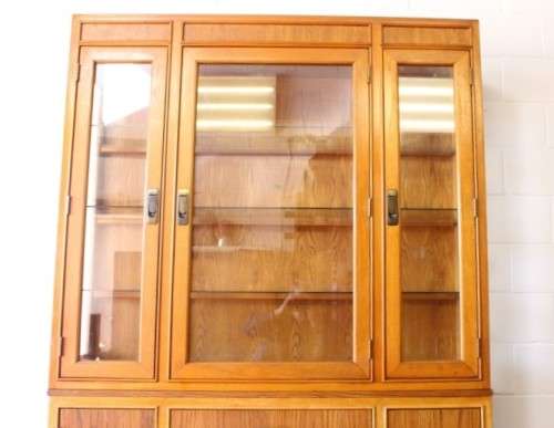 **RS17** A tall 3-door oak display cabinet with lighting, four drawers and two storage cupboards