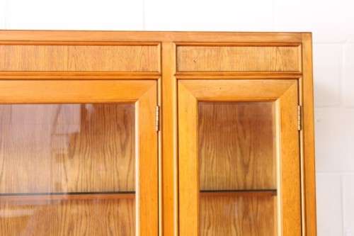 **RS17** A tall 3-door oak display cabinet with lighting, four drawers and two storage cupboards