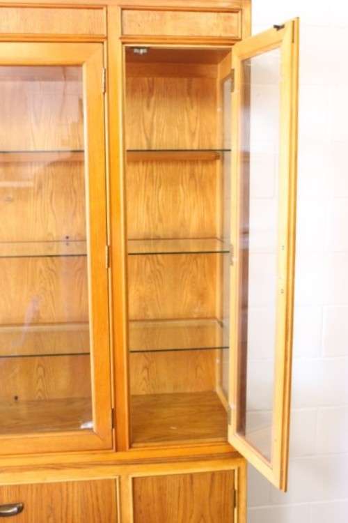 **RS17** A tall 3-door oak display cabinet with lighting, four drawers and two storage cupboards