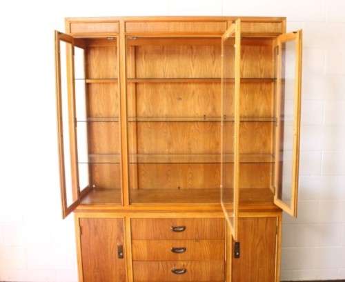 **RS17** A tall 3-door oak display cabinet with lighting, four drawers and two storage cupboards