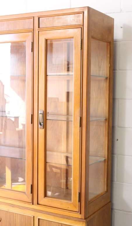 **RS17** A tall 3-door oak display cabinet with lighting, four drawers and two storage cupboards