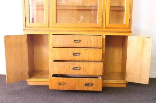 **RS17** A tall 3-door oak display cabinet with lighting, four drawers and two storage cupboards