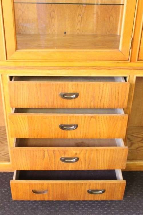 **RS17** A tall 3-door oak display cabinet with lighting, four drawers and two storage cupboards