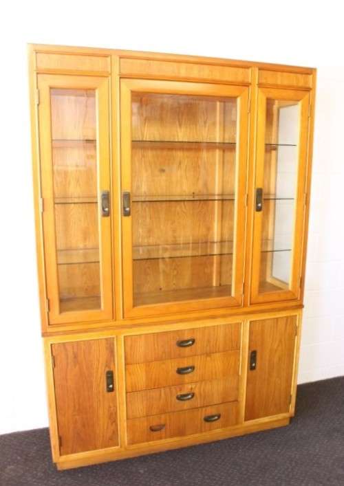 **RS17** A tall 3-door oak display cabinet with lighting, four drawers and two storage cupboards