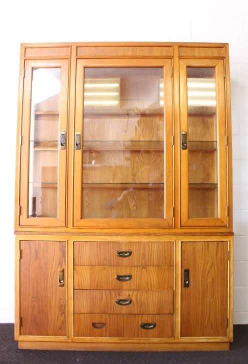 **RS17** A tall 3-door oak display cabinet with lighting, four drawers and two storage cupboards