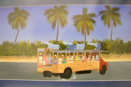 **RS17** A colourful signed and framed behind glass "Robert Nesta" painting "Dala Dala" Zanzibar.