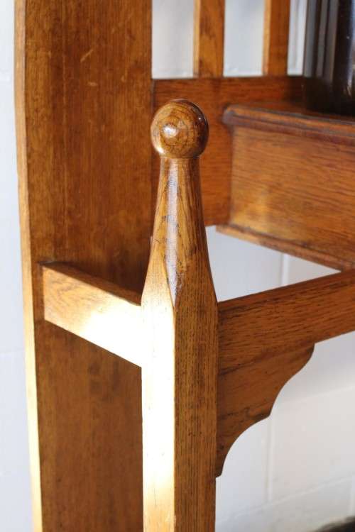 An incredible solid Oak hall stand with a bevelled mirror, drawer and six hooks for hats and coats!