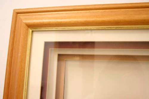 Two stunning mini ceramic masks in a lovely wooden boxed frame.
