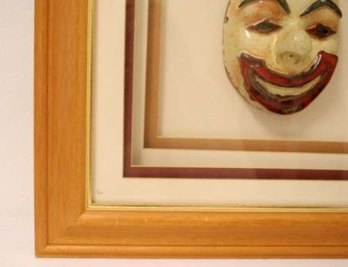 Two stunning mini ceramic masks in a lovely wooden boxed frame.