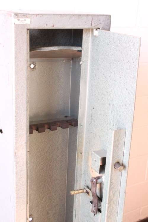 A well made 1.3m tall 4-rifle steel safe with a hand-gun/ ammunition/ key shelf