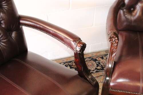 A magnificent large PU leather Gainsborough armchair w/ carved detailed armrests - 2x Available