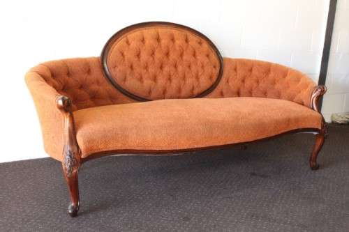A beautiful antique Victorian Walnut deep-button camel-back sofa with stunning hand-carved detailing