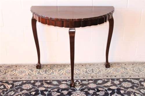 A stylish vintage solid Imbuia ball and claw half moon display/occasional table w/ a scalloped edge