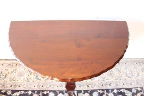 A stylish vintage solid Imbuia ball and claw half moon display/occasional table w/ a scalloped edge
