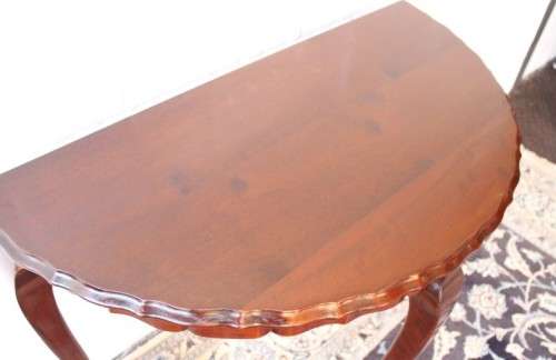 A stylish vintage solid Imbuia ball and claw half moon display/occasional table w/ a scalloped edge