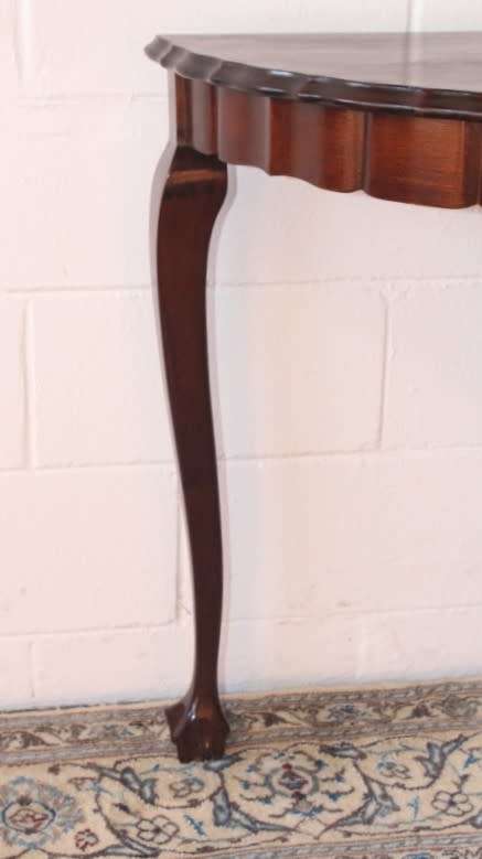 A stylish vintage solid Imbuia ball and claw half moon display/occasional table w/ a scalloped edge